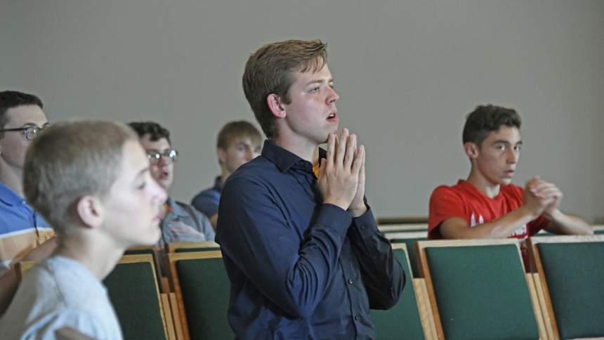 Discerners including Colin Cyzon (center), 17, of Our Lady of Grace parish, participate in Eucharistic Adoration during the Vocasti Me gathering at St. Paul in Valparaiso on July 14, 2023. Diocesan vocations director Father Nate Edquist recently announced a new initiative named Called By Name, which, like the discerners gatherings, promotes vocations to the priesthood, but asks other church-goers to note and nominate young men who they observe may prosper in a priestly calling. (Anthony D. Alonzo photo)