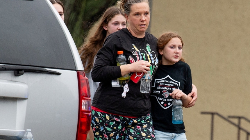 A family leaves the scene of a mass shooting at Abundant Life Christian School in Madison, Wis., Dec. 16, 2024. At least two people are dead, in addition to the suspect, and others are injured, after the mass shooting, police said. (OSV News photo/Cullen Granzen, Reuters)