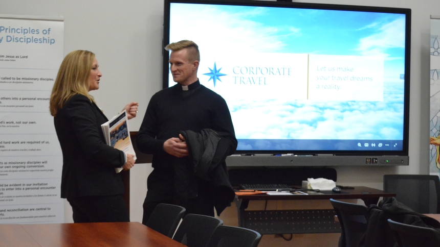 Christine Shewchuck, of Corporate Travel, talks with Father Nathaniel Edquist prior to a meeting on Nov. 21 about a diocesan pilgrimage to Rome next year. Both Father Edquist and Bishop Robert J. McClory will be participating in the pilgrimage scheduled for Fall 2025. (Erin Ciszczon photo)