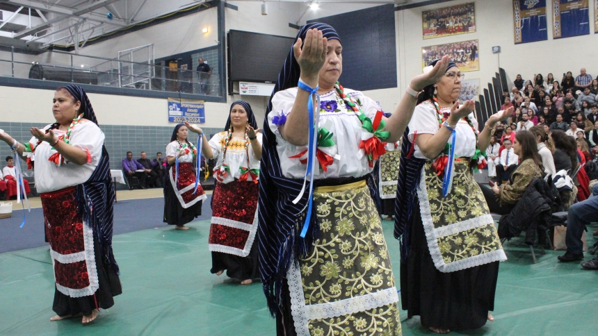 Costumed as peasant women, and carrying small candles in their hands, dancers from St. Margaret Mary church closed the Mass on Dec. 8 in honor of the Immaculate Conception and Our Lady of Guadalupe. With a congregation of more than 500 expected, the liturgy celebrated by Bishop Robert J. McClory was held at the Bichop Noll Institute fieldhouse next to the church. (Marlene A. Zloza photo)
