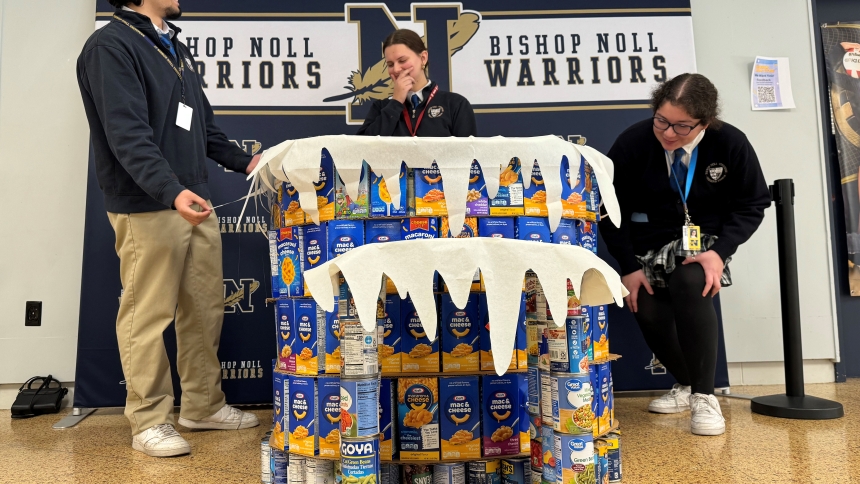 Bishop Noll Institute seniors (left to right) Dusan Knezevic, Gianna Gaal and Anna De La Torre inspect their food sculpture made of donations from fellow Warriors for the Catholic Charities food drive, in Hammond on Dec. 2. Catholic Charities food pantry manager Tina Gunnum praised the efforts of the teens at Bishop Noll and Marquette Catholic High School in Michigan City and said the need remains strong for donations from local faithful to endeavor to fulfill the minstry's charge to feed the hungry. (Antho