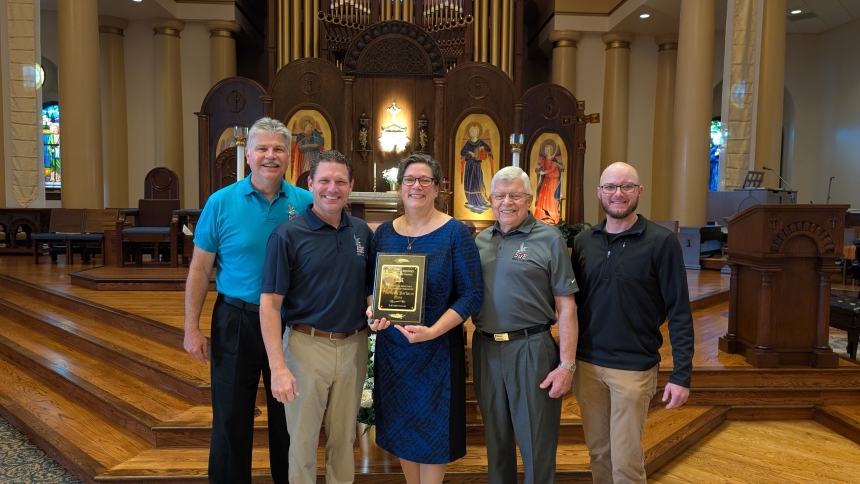Ken Kolodziej, Dan Ditola and Ed Schneider of the St. John the Evangelist Men's Club present the 2024 Sylvester Reising Stewardship Award to Theresa Birlson together with Danny Reising. Reising is the great grandson of Sy Reising for whom the award is named. (Provided photo) 