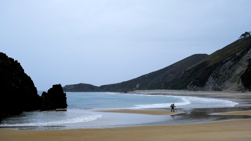 Cesar, a pilgrim from Mexico, walks on the San Antolin beach in Llanes, Spain, Sept. 24, 2022, while continuing his pilgrimage along El Camino de Santiago del Norte. According to the pilgrims' office in Santiago de Compostela, a record 499,239 pilgrims from all over the world walked Spain's famed Camino in 2024. (OSV News photo/Nacho Doce, Reuters)