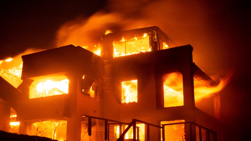 Flames rise from a structure as the Palisades Fire burns during a windstorm on the west side of Los Angeles Jan. 8, 2025. Firefighters battled early Jan. 9 to control a series of major fires in the Los Angeles area that have killed five people, ravaged communities from the Pacific Coast to Pasadena and sent thousands of people frantically fleeing their homes. (OSV News photo/Ringo Chiu, Reuters)