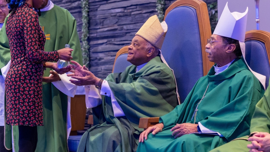 Washington Cardinal Wilton D. Gregory receives offertory gifts from a young woman during a Mass Jan. 19, 2025, celebrated at Holy Family Church in Hillcrest Heights, Md., to commemorate the legacy of the Rev. Dr. Martin Luther King Jr. At right is Washington Auxiliary Bishop Roy E. Campbell Jr., one of the concelebrants at the Mass. Martin Luther King Jr. Day, the federal holiday observed on the third Monday of January each year, was Jan. 20. (OSV News photo/Mihoko Owada, Catholic Standard)          