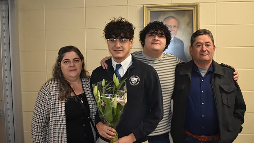 Sergio Meza (second from left), a senior at Bishop Noll Institute in Hammond, was surprised last month when the school announced that he is one of only six Lake County students to earn a prestigious Lilly Scholarship. On hand for the announcement are his parents, Maria and Aurelio Meza, and his older brother and BNI alumnus Ulises Meza. (Provided photo)