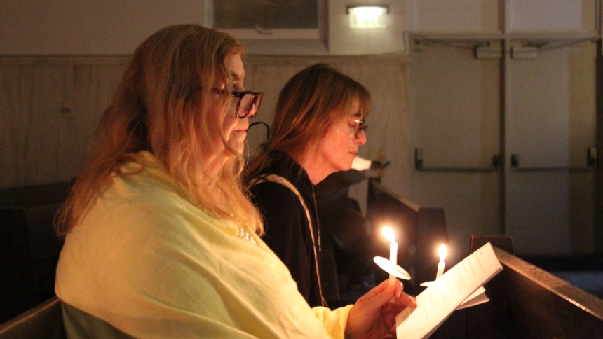 Tamara and Marsha Browne, who earlier led the congregation in reciting "The Memorare," participate in a candlelight vigil for Michael and Pegg Sangerman on Dec. 30 at St. Mary of the Lake in Gary. "It was Pegg's favorite prayer," said Tamara Browne of the shooting victim who succumbed to her injuries on Dec. 18. An estimated 200 community members attended the prayer vigil as Michael Sangerman remained hospitalized. (Marlene A. Zloza photo)