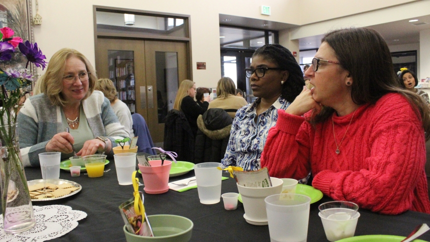 St. Matthias parishioners and Crown Point residents (from left) Linda Plewniak, Ugochi Okoro and Beth Cooke compare notes of what makes each of them "fiercely unique," like wildflowers are, during the Celebrate Women Event held on Jan. 26 at the Parish Center. Keeping with the theme, the attendees each took home a packet of flower seeds in a small pot, with a miniature shovel for planting. (Marlene A. Zloza photo)