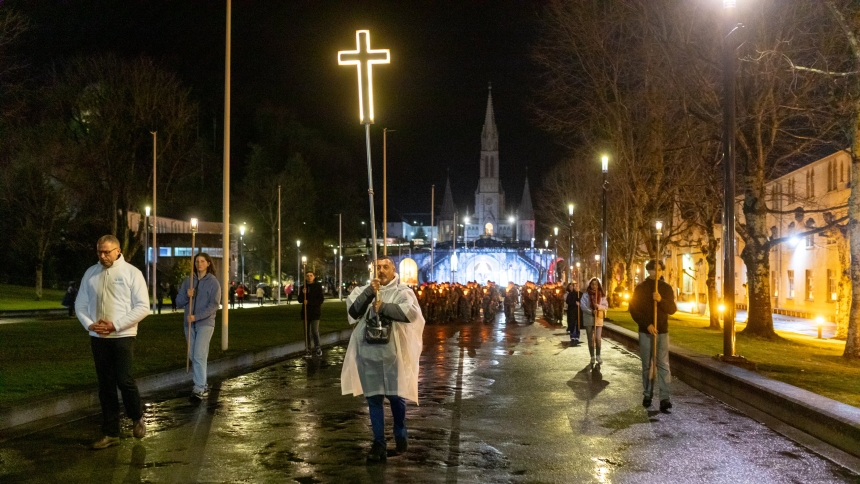 A pilgrim carries a illuminated cross as he leads the traditional candlelit procession on Our Lady of Lourdes feast Feb. 11, 2024, in the shrine of Our Lady of Lourdes in southern France. Even though a pilgrimage peak was some months away, the shrine celebrated its wintery feast day in 2025 with a number of pilgrims who flocked to the mountain-based French holy site on the Feb. 11 anniversary of the first apparition of the Blessed Virgin to St. Bernadette Soubirous in 1858. (OSV News photo/courtesy Lourdes 