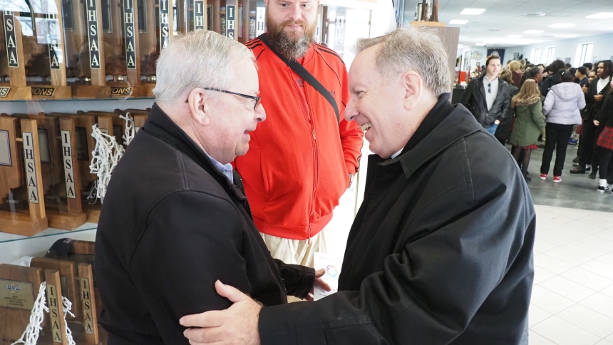 Bishop Robert J. McClory greets Brother Shaun Gray in the Marquette Catholic High School Scholl Center prior to the start of the all-city Catholic Schools Week Mass on Jan. 30. The bishop thanked Gray for his service to the Michigan City community. (Deacon Bob Wellinski photo)