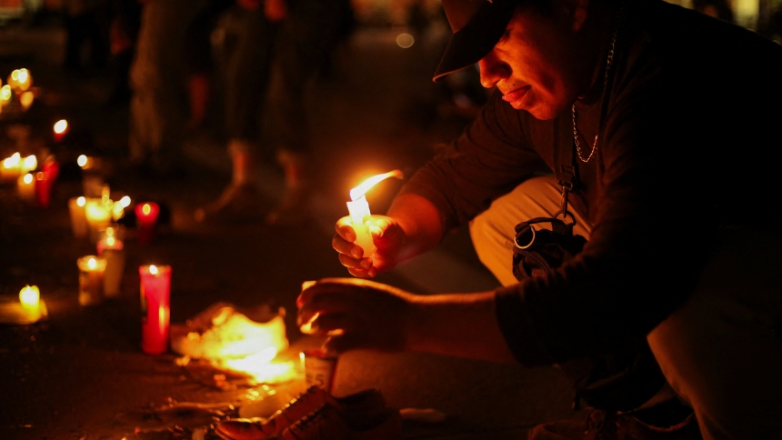 A man lights a candle during a vigil at Zocalo square, in Mexico City, Mexico March 15, 2025, for the victims of the clandestine mass grave recently found in Teuchitlan, in the state of Jalisco. Mexico's Catholic leaders prayed for the country's missing and urged the population of the country and their political leaders to listen to victims of violence amid outrage over the discovery of mass graves and ovens for cremating bodies on a drug cartel compound. (OSV News photo/Seila Montes, Reuters)