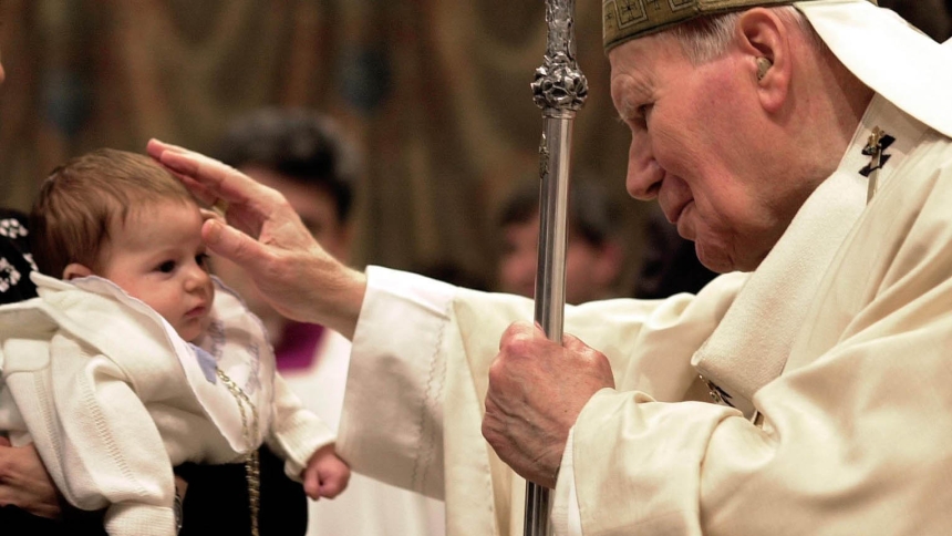 Pope John Paul II, who later became St. John Paul II,  blesses a baby during an annual baptism liturgy in the Vatican's Sistine Chapel Jan. 13, 2002. (OSV News photo from Catholic Press Photo)  