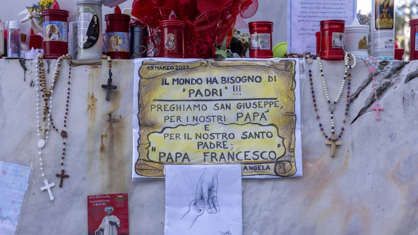 Devotional items are seen at the base of a statue of St. John Paul II outside of Rome's Gemelli hospital March 19, 2025. (CNS photo/Pablo Esparza)