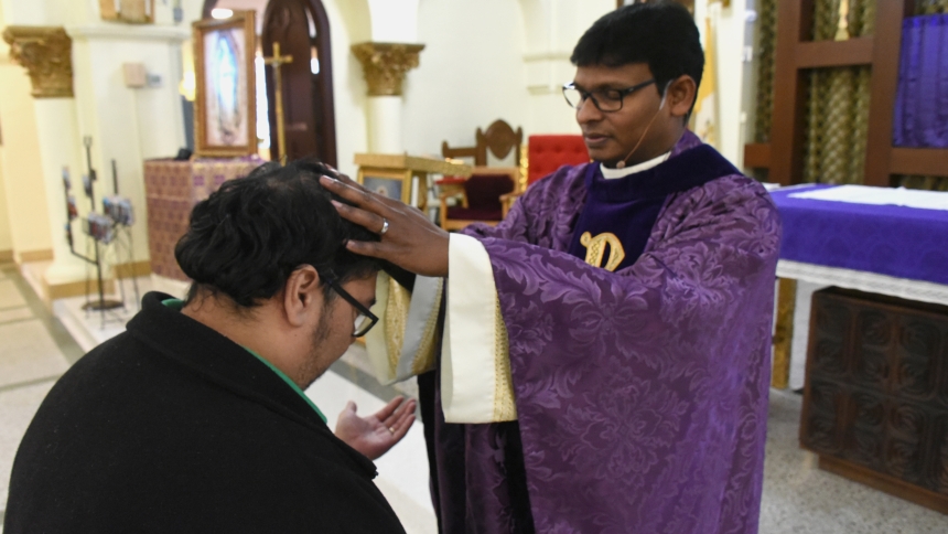 David Maldonado (left) approaches Father Jayababu Nuthulapati (right), administrator of Sacred Heart parish, who imparts a blessing during the Mass of Healing in Whiting. Many parishioners and guests reported a lifting up of their spirits and more belief in God's healing power on March 15, after participating in the liturgy and receiving individual blessings from their Missionary of Mercy priest. (Anthony D. Alonzo photo) 