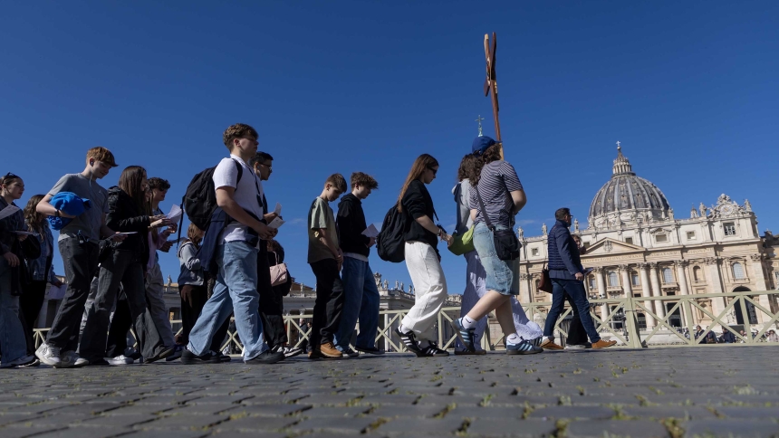 A group of pilgrims walk through St. Peter's Square at the Vatican on their way to the Holy Door of St. Peter's Basilica April 2, 2025. Pope Francis is convalescing and not able to meet the pilgrims. (CNS photo/Pablo Esparza)
