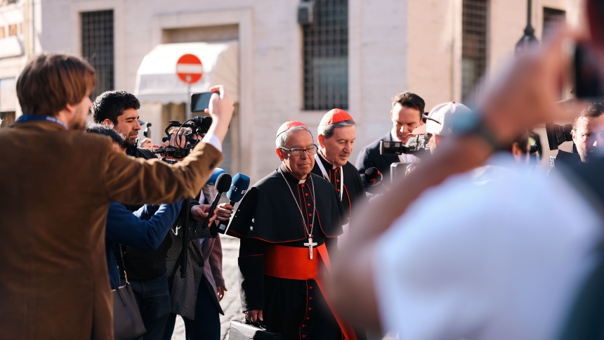 Cardinals Luis José Rueda Aparicio of Bogotá, Colombia, left, and Rubén Salazar Gómez of Bogotá, right, approach the Petriano entrance of the Vatican next to St. Peter's Square to attend the seventh general congregation meeting of cardinals April 30, 2025. (CNS photo/Kendall McLaren)