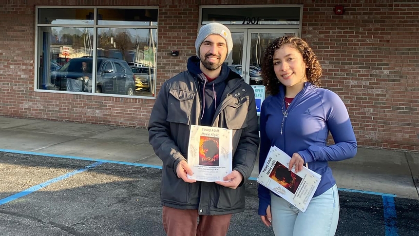 St. Mary of the Lake young adult group coordinator Albert Alfano (left) and parishioner Naomi Perez Mendez (right) hand out brochures at the Planet Fitness gym in Hobart in April. Leaders at the church in the Miller section of Gary have developed a ministry for young Catholics and continue outreach, including direct marketing, to help grow the initiative. (provided photo) 