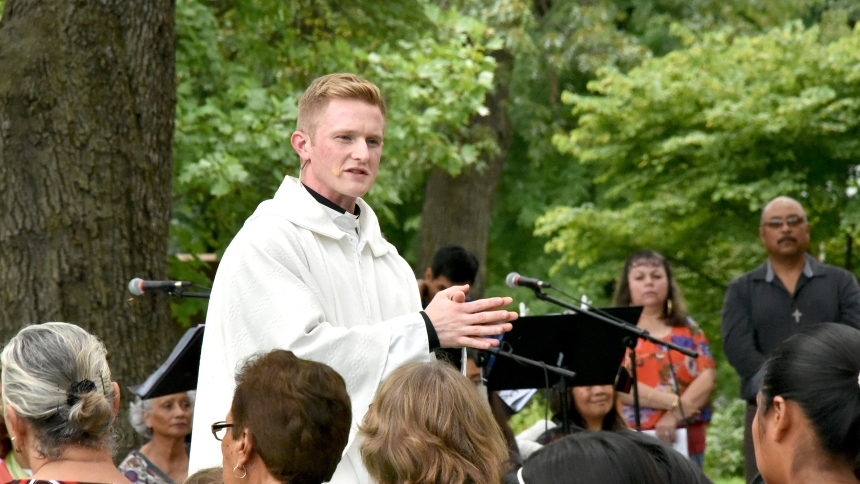 Father Nathaniel Edquist (top), vocations director and pastor of Holy Family Parish, delivers his homily alternating between English and Spanish to those attending the Mass for migrants at Herr Farms in Lowell in this file photo. The LaPorte priest believes that God draws His people to be reconciled with Him, and a sure may for the sinner to remain in a state of grace is through regular sacramental confession. (NWIC file photo/Anthony D. Alonzo)