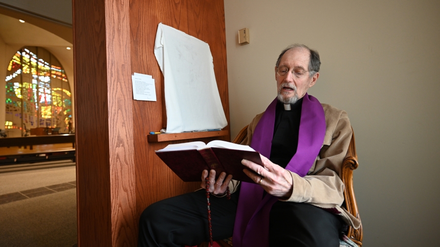 Father Douglas Mayer, pastor of St. Paul, prays in the confessional at the Valparaiso church on April 9. A penitent experiences the "power of the Risen Lord" in the sacrament of reconciliation, according to Father Mayer, who recalled his own journey of sacramental forgiveness. (Anthony D. Alonzo photo)