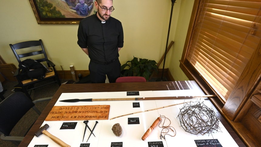 Father Robert Ross, associate pastor of St. Michael the Archangel church, views instruments of punishment associated with the passion of Jesus Christ, on March 31 at the Schererville parish. Father Ross and his dad Tom Ross will deliver a presentation about the Shroud of Turin, the linen many believe to be the Lord's burial cloth, at the parish on Easter Monday, April 21. (Anthony D. Alonzo photo) 