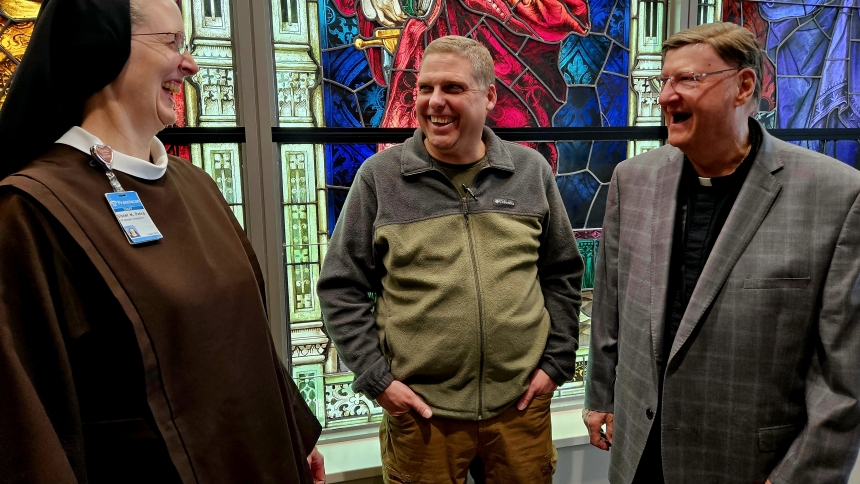 Sister M. Petra Nielsen, vice president of mission integration for Franciscan Health’s Northern Division, shares a laugh with her younger brother, James Nielsen and the Rev. Tony Janik during a recent reunion in the St. James Chapel at Franciscan Health Crown Point.
