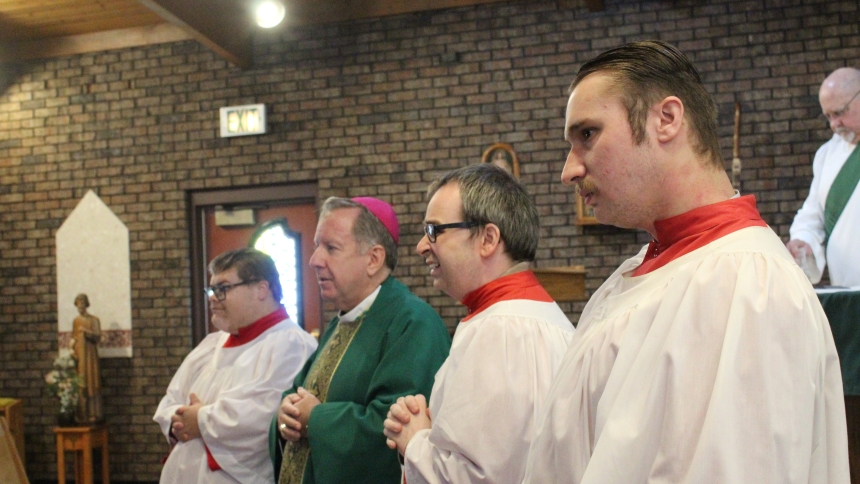 Bishop Robert J. McClory stands with the three most faithful altar servers at St. Stephen, Martyr during the parish's closing Mass on Feb. 15, (from left) Zak Campbell of Merrillville, Chris Neff of Crown Point and George Perosky of Merrillville.  At right is Deacon Rob Litavecz, who trained the young men. (Marlene A. Zloza photo)