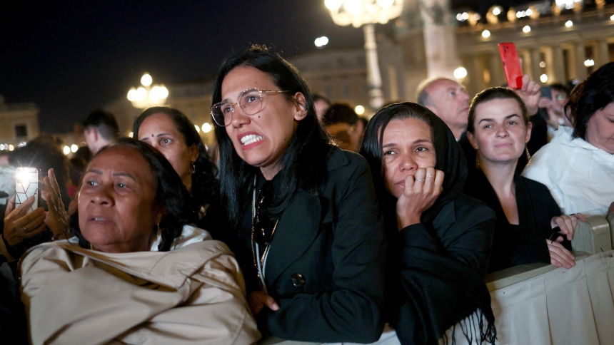 Women react as black smoke billows from the chimney on the Sistine Chapel May 7, 2025, on the first day of the conclave. The black smoke indicated that cardinals did not elect a new pope. (OSV News photo/Eloisa Lopez, Reuters)