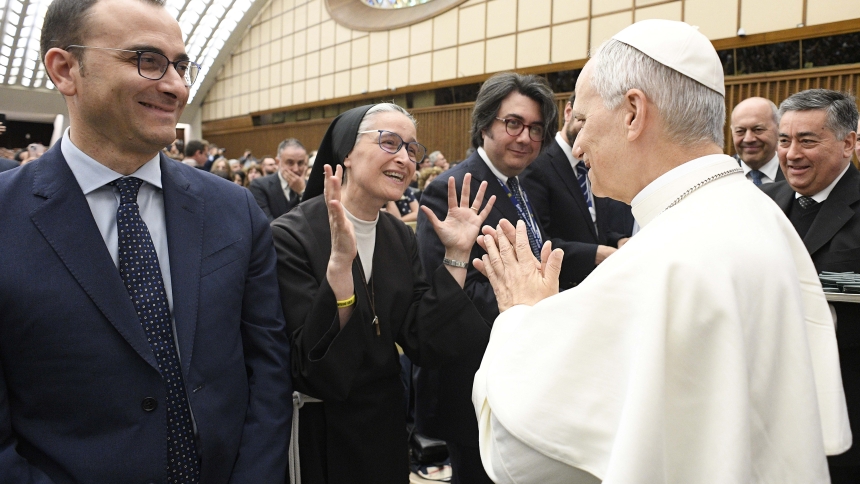 Using sign language Franciscan Sister Veronica Donatella applauds Pope Leo XIV during a meeting with members of the media May 12, 2025, in the Paul VI Audience Hall at the Vatican. Sister Donatella provides Italian sign language interpretation for Vatican Media. (CNS photo/Vatican Media)