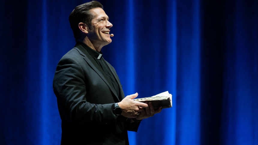 Father Mike Schmitz, a priest of the Diocese of Duluth, Minn., and host of "The Bible in a Year" podcast, speaks to the crowd at a previous Parables Tour in 2025. Father Mike took the tour to Constitution Hall in the nation's capital May 19, 2025. (OSV News photo/courtesy Ascension)