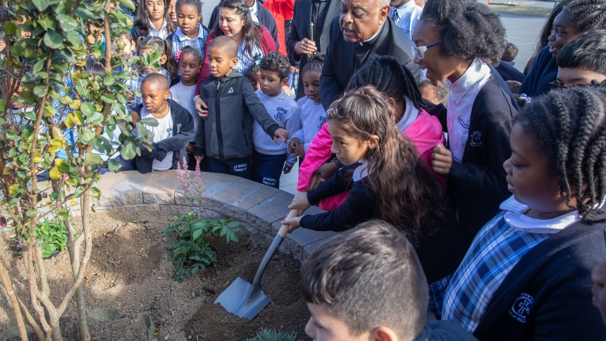 In this 2019 photo, then-Archbishop Wilton D. Gregory of Washington joins students at St. Mary's School in Landover Hills, Md., in planting a tree in celebration of the school's 65th anniversary. In advance of the 10th anniversary of the late Pope Francis' encyclical "Laudato Si'," the U.S. bishops' conference recognized the impact the climate crisis has on young people and encouraged their strong witness and leadership for a better future. (OSV News photo/Andrew Biraj, Catholic Standard)