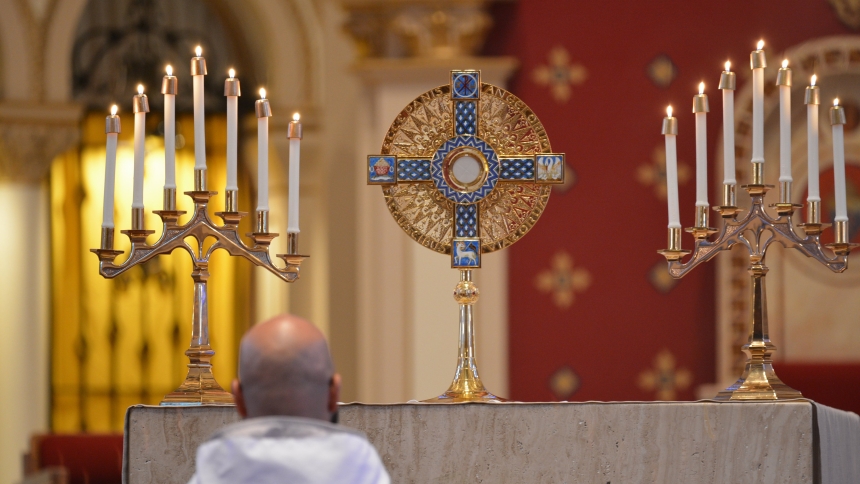 A chaplain for the perpetual pilgrims along the St. Katherine Drexel route of the National Eucharistic Pilgrimage prays before the Eucharist during a Holy Hour May 28, 2025, at St. Ambrose Cathedral in Des Moines, Iowa. (OSV News photo/Anne Marie Cox, Diocese of Des Moines) 