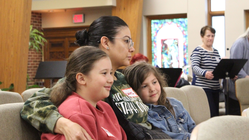 Listening to prayers for comfort and an end to suffering, mother and daughters (from left) CeCe, Cris and Luna Mundo, of Winfield, participate in a Healing Mass at Holy Spirit in Winfield on May 21. (Marlene A. Zloza photo)