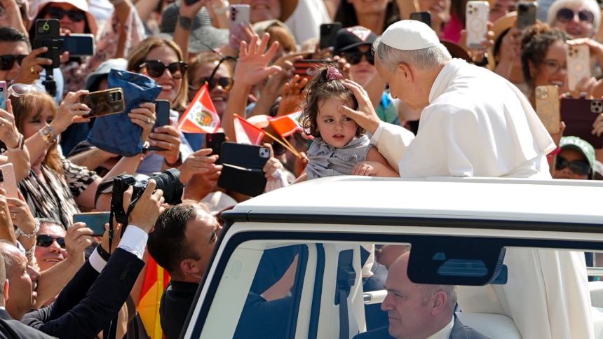 Pope Leo XIV greets a child from the popemobile as he rides around St. Peter's Square at the Vatican before his weekly general audience June 11, 2025. (CNS photo/Lola Gomez)