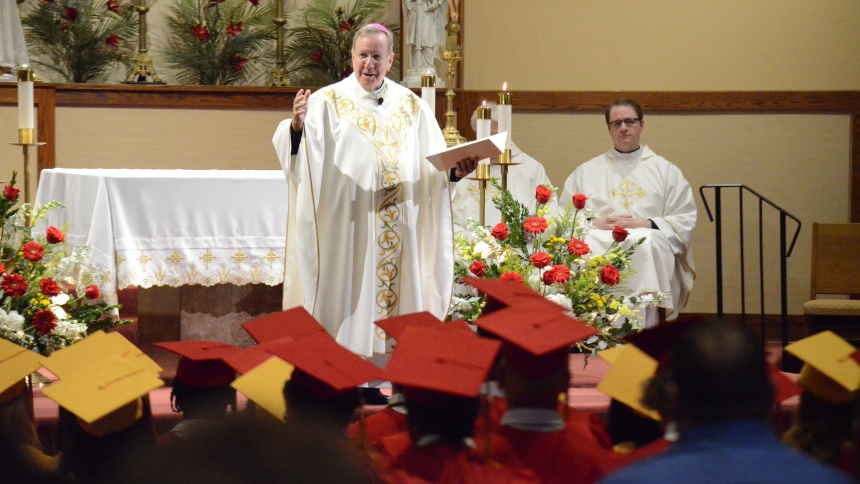 Bishop McClory talks with graduating students from Andrean High School.