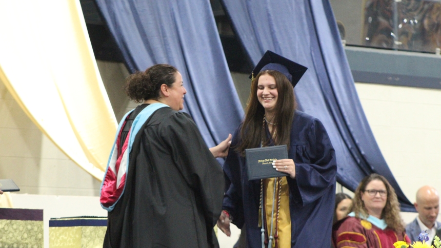 Gianna Marie Gaal wears a big smile as she receives her Bishop Noll Institute diploma from principal Lorenza Jara Pastrick on June 5. One of 123  graduates, Gaal will attend Purdue University Northwest after receiving more than a dozen scholarship offers. (Marlene A. Zloza photo)