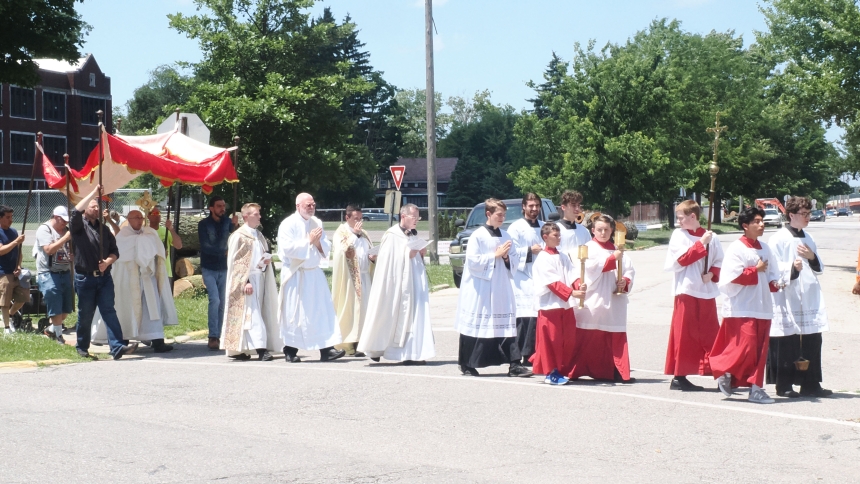 Following the 12:00 p.m. Mass at Holy Family Parish-St Joseph Church, parishioners, along with the Knights of Columbus Color Guard, joined in a procession on the Feast of Corpus Christi on June 22. The nearly two-mile procession through downtown LaPorte made a brief stop in front of St Peter Church then on to Sacred Heart Church for benediction. Ice cream was available for a cold refreshing treat on a day that saw temperatures well into the 90’s. (Michael Wellinski photo)