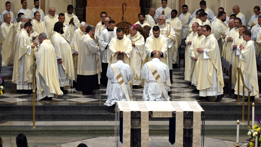 Priest-elect Ivan Alatorre (middle, left) is prayed over by Father Eduardo Malagon and priest-elect Alexander Kouris (middle, right) is prayed over by Father Robert Ross during the laying on of hands at the Mass of Ordination in the Cathedral of the Holy Angels in Gary on June 7. The faithful welcomed two new priests – Father Alatorre and Father Kouris – and transitional Deacon WIlliam O'Donnell, who entered new ministries as "ambassadors of Christ," according to the presider of the Mass of Ordination, Bish