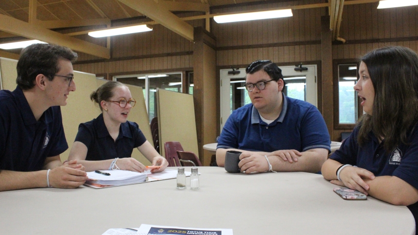 Talking over their plans for the Totus Tuus summer program that began June 7-13 at St. John the Evangelist in St. John is one of two teams of missionaries for the Diocese of Gary, (from left) Brendan Loughran from Canandaigua, New York; Caroline Wildfang from LaPorte; Parick Cullars, a seminarian from Munster; and Emily May from Abita Springs, Louisianna. The group trained at Camp Larence in Valparaiso from May 29-June 6. (Marlene A. Zloza photo)