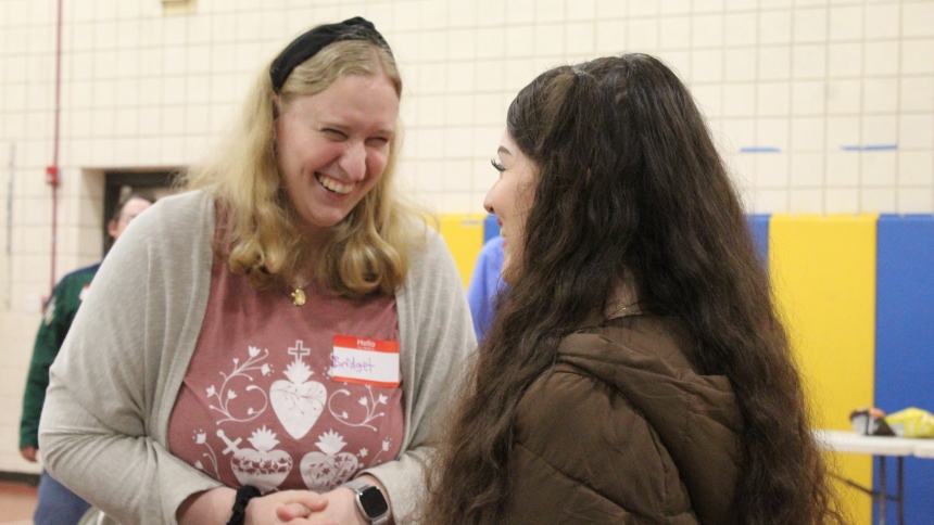 Bridget Conry, of Schererville, a parishioner at Our Lady of Consolation in Merrillville, gets acquainted with Lorely Mora, a parishioner at St. Mary in East Chicago, during an icebreaker before Sister M Josetta Rose’s talk at St. Joseph in Dyer. A Young Adult Summer Speaker Series is bringing young people through age 39 together to share their faith as well as food and fellowship. (Marlene A. Zloza photo)