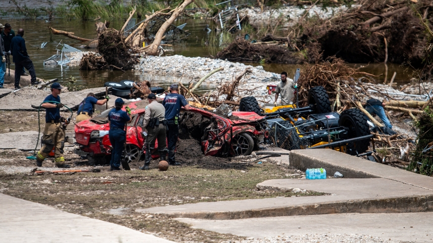 First responders attend to a vehicle pulled from the water in the aftermath of deadly flooding in Kerrville, Texas, July 6, 2025. At least 82 people are dead and at least 41 more are missing after devastating flash floods slammed the Texas Hill Country, with water rescues taking place along the Guadalupe River, which rose rapidly early July 4 to the height of a two-story building. Among the missing were almost a dozen from Camp Mystic in Kerr County, a children's summer camp, officials said July 6. (OSV New