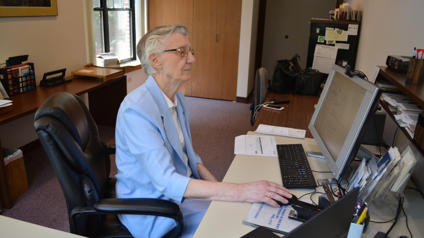 Sister Joaquina Costa of the Missionary Sisters of the Sacred Heart of Jesus, director of the Mother Cabrini League, is seen working on her computer July 7, 2025, at the league's office on the Northside of Chicago. (OSV News photo/Simone Orendain)