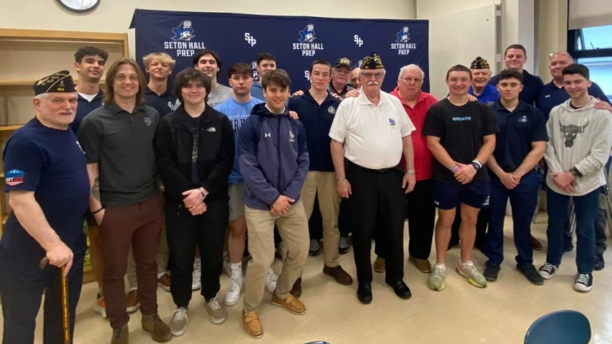 Students from Seton Hall Preparatory School in West Orange, N.J., and American veterans pause for a group picture in this undated photo. For the past 10 years, Seton Hall Prep's Veterans Service Club has allowed student participants to brighten vets' lives through volunteer work and social gatherings. (OSV News photo/courtesy of Jersey Catholic)