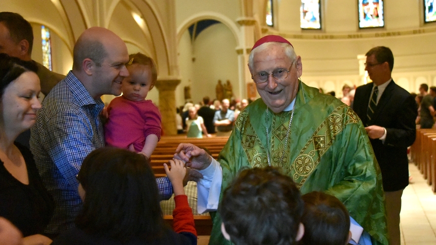 Bishop emeritus Carl F. Mengeling of Lansing, Mich. greets the faithful at the conclusion of the 150th anniversary Mass of the founding of the parish school at St. Thomas the Apostle in Ann Arbor, on Sept. 8. Bishop Mengeling was part of the Diocese of Gary inaugural ordination class and served as a high school and college instructor and pastor at parishes including St. Mark, All Saints in Hammond, Holy Name, Nativity of Our Savior, and St. Thomas More, before being ordained as a bishop in Jan. 1996. (Antho
