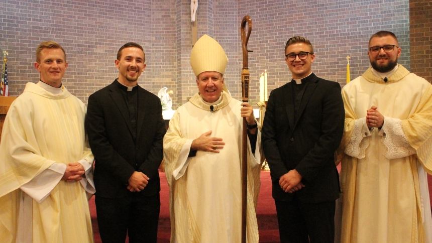 Father Nathaniel Edquist (left), Diocese of Gary vocations director, Bishop Robert J. McClory (center) and Transitional Deacon Will O’Donnell (right) congratulate seminarians Ryan Pierce (second from left) and Gianni DiTola following the Mass for the Rite of Admission to Candidacy for Holy Orders on July 8 at St. James the Less in Highland. The two seminarians will head to Rome, Italy later this month to continue their studies at the Pontifical North American College. (Marlene A. Zloza photo)