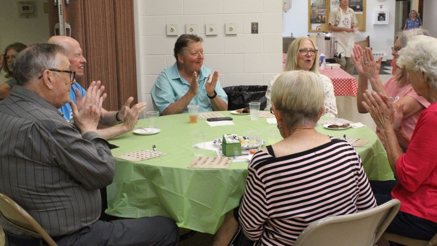 Bingo players clap after one of their tablemates won a game during the annual parish picnic at St. Elizabeth Ann Seton in Valparaiso on July 20. White elephant prizes were supplied by parishioners, who also brought potluck side dishes and desserts to share. The parish provided hamburgers, hot dogs and brats grilled by volunteers. (Marlene A. Zloza photo)