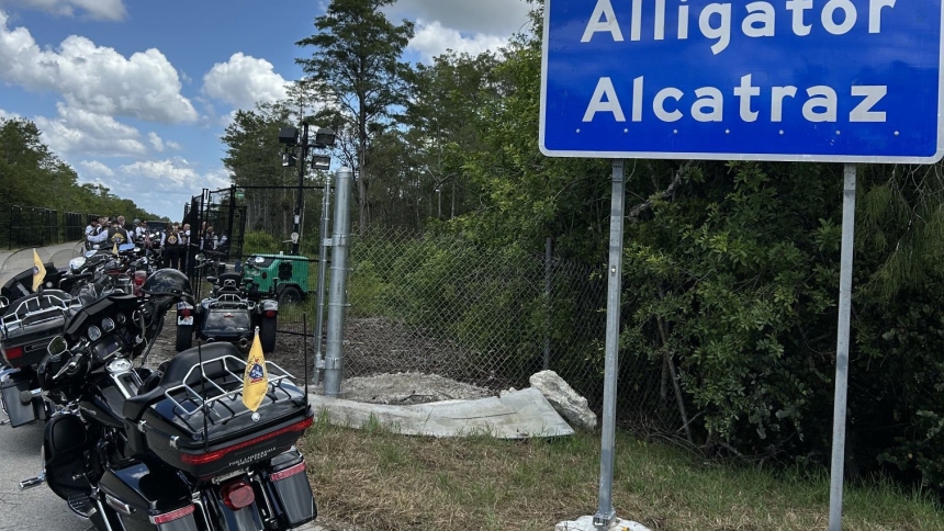 Motorcycles ridden by Archbishop Thomas G. Wenski of Miami and members of Knights on Bikes are parked in front of the entrance to "Alligator Alcatraz," an immigration detention facility some 55 miles from Miami in the Florida Everglades. The archbishop and his fellow bikers stopped to pray a rosary for detainees July 20, 2025. (OSV News photo/Archbishop Thomas G. Wenski)