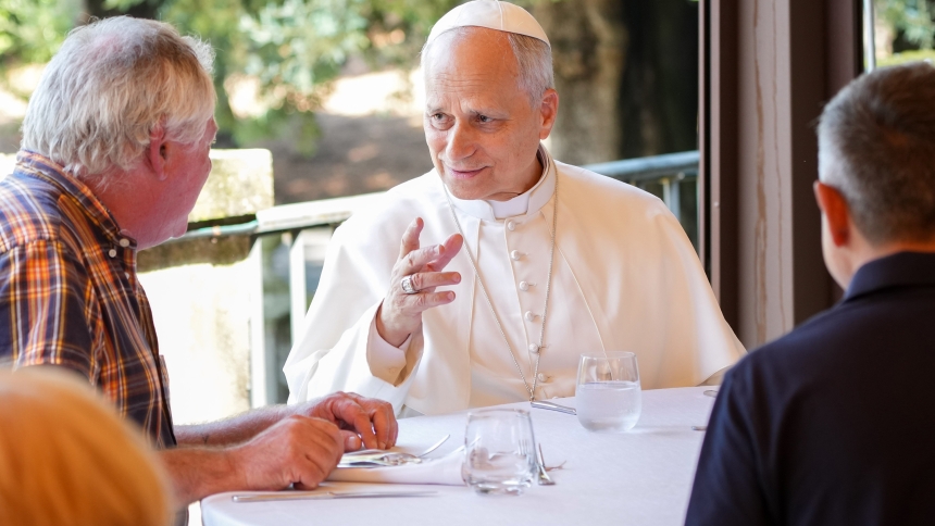Pope Leo XIV shares a moment with guests assisted by the Albano diocesan Caritas agency during a luncheon at the Borgo Laudato Si’ in Castel Gandolfo, Italy, Aug. 17, 2025. (CNS photo/Lola Gomez)
