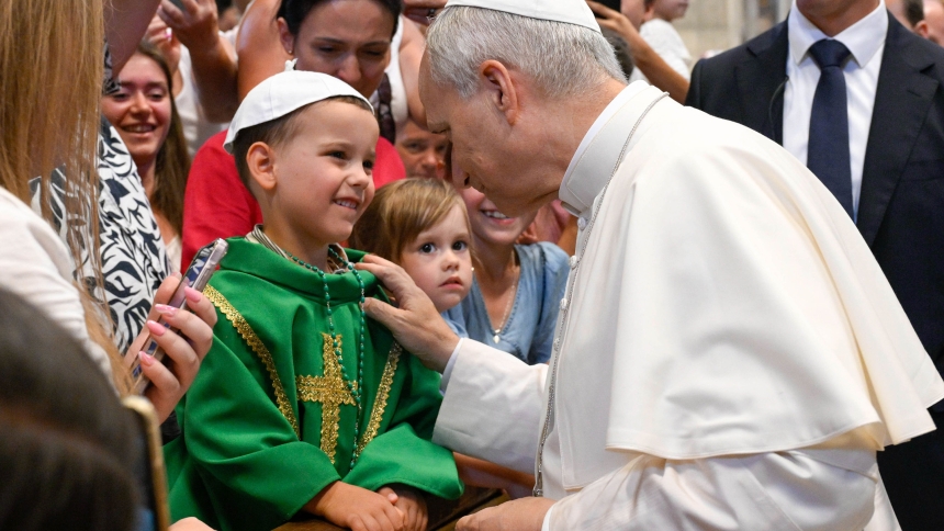 Pope Leo XIV greets a child dressed in liturgical vestments inside St. Peter’s Basilica at the Vatican Aug. 20, 2025, after his weekly general audience. The pope visited pilgrims gathered in the basilica to offer his blessing, as the Paul VI hall had reached full capacity. (CNS photo/Vatican Media)