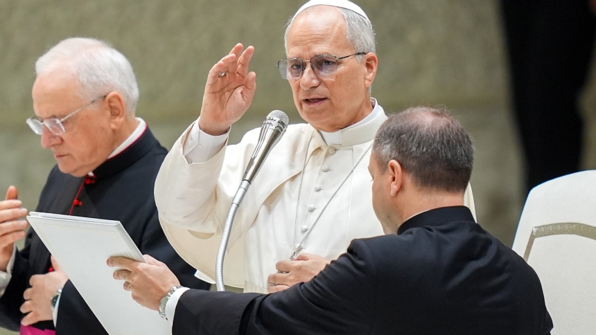 Pope Leo XIV gives his blessing to visitors and pilgrims at the conclusion of his weekly general audience in the Paul VI Audience Hall at the Vatican Aug. 27, 2025. (CNS photo/Lola Gomez)