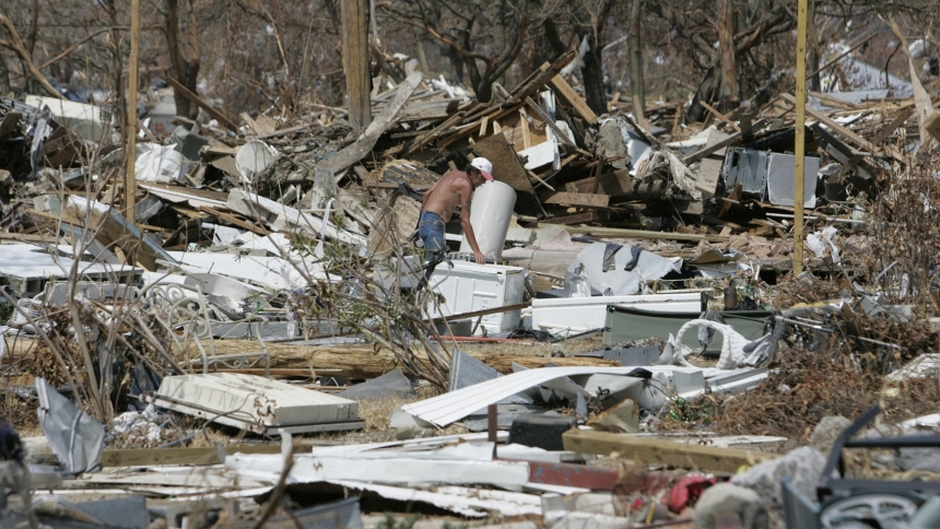 Pat DeSilvey, a Catholic from Biloxi, Miss., tries to salvage items from his destroyed home Sept. 9, 2005, in the aftermath of Hurricane Katrina. Aug. 29, 2025, marks the 20th anniversary of the deadly storm, which made landfall in the Gulf Coast region. The powerful storm claimed 1,400 lives, and caused widespread devastation, particularly in New Orleans and along the Mississippi coast. (OSV News photo/Bob Roller)